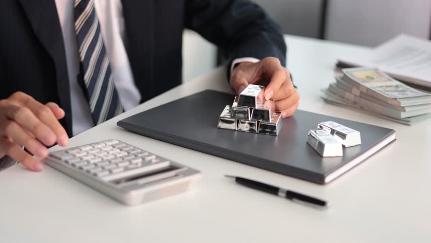 Silver Trading Businessman invest in trading silver, calculating profit price of buying and selling silver in the market.
