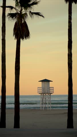 Slow motion. Lifeguard cabin on a peaceful sunset.