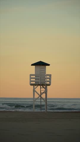 Slow motion. Lifeguard cabin on a peaceful sunset.