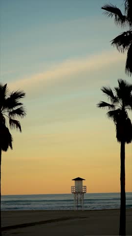 Slow motion. Lifeguard cabin on a peaceful sunset.