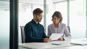 Businesswoman and businessman reading paperwork document in office. Latin woman accountant analyst holding document working with European client man doing trade market financial data base bank report - Powered by Shutterstock - Get 15% off with code: PIKWIZARD15