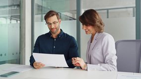 Latin woman accountant analyst holding document working with European client man doing trade market financial data base bank report. Businesswoman and businessman reading paperwork contract in office - Powered by Shutterstock - Get 15% off with code: PIKWIZARD15