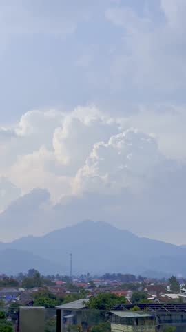 A dormant volcano stands in the distance beneath soft cloud cover, creating a moody and scenic mountain view.
