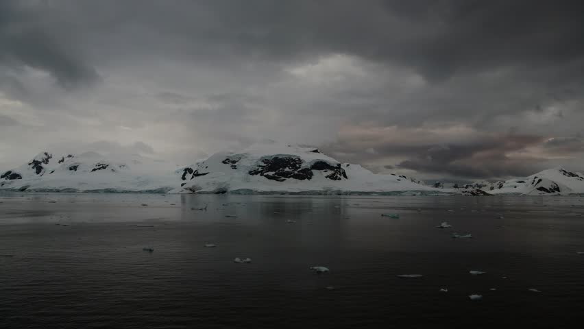 Stunning sunset over icy waters with floating icebergs in Antarctioca