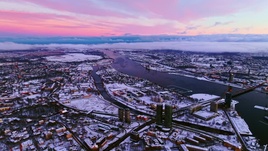 Morning sunlight glows through smoky rooftops in cold southeast Riga view