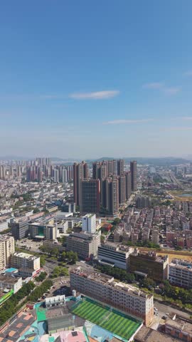 Vast vertical aerial of the Shenzhen outskirts skyline. Captures the intense urban sprawl and development, contrasting the core high-rises with surrounding lower-density areas and open lots, China