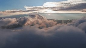 Cinematic aerial view of sun rays (God rays) piercing through dramatic storm clouds over a mountain silhouette. A moody sunrise in the Marilog District highlands creating a spiritual atmosphere. - Powered by Shutterstock - Get 15% off with code: PIKWIZARD15