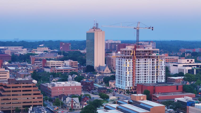 Aerial view of downtown Ann Arbor with construction crane and city buildings at dusk, Michigan, USA
