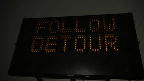 Warning display sign of closed road. Portable and Electronic Traffic Signs at night misty weather. POV close up view - Powered by Shutterstock - Get 15% off with code: PIKWIZARD15
