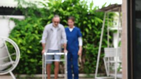 An elderly man with weak muscles in his legs has Alzheimer's disease and is being helped by a walker. A nurse is taking care of him in a nursing home.
 - Powered by Shutterstock - Get 15% off with code: PIKWIZARD15