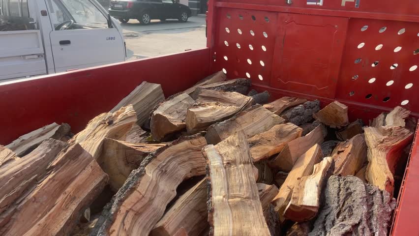 15 October 2025, Fergana, Uzbekistan – A small village truck transporting a load of firewood through a rural area, illustrating traditional rural life.