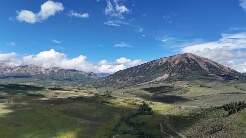 Aerial View of Mount Crested Butte and Green Landscape of Elk Mountains on Sunny Summer Day, Colorado USA