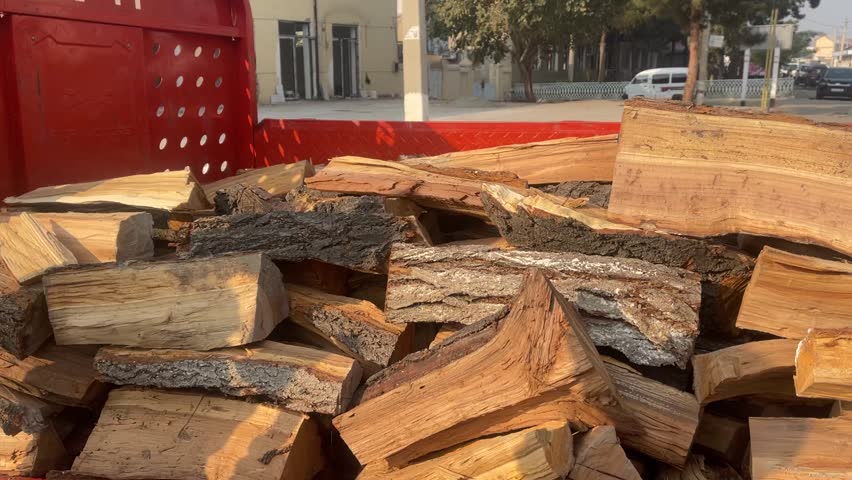 15 October 2025, Fergana, Uzbekistan – A small village truck loaded with firewood, parked in a rural area, illustrating traditional rural life.
