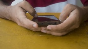 Footage displays hands using a smartphone on a table, showcasing mobile technology interaction. The clip emphasizes connectivity, communication, and digital lifestyle in a modern context. - Powered by Shutterstock - Get 15% off with code: PIKWIZARD15