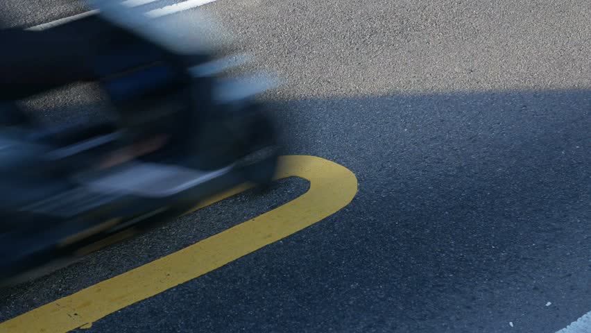 low angle view to the asphalt street highway road with traffic of cars, motorbikes and electricity scooter in Rush hour time. Abstract background low angle life style street view