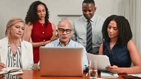Diverse Business Team Collaborating and Discussing Strategy Around a Laptop in a Modern Office Meeting - Powered by Shutterstock - Get 15% off with code: PIKWIZARD15