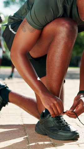 Black man, hands and tying shoes with preparation for workout, exercise or outdoor training. Active, male person or tie with sneakers, lace or getting ready for fitness run, sprint or race in park