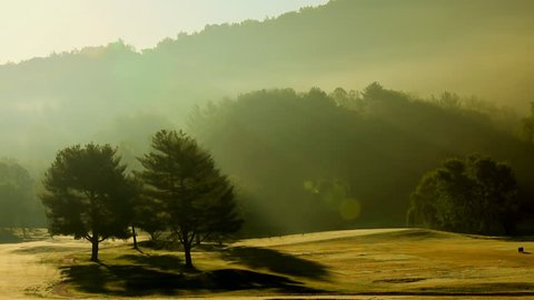 Time lapse of fog lifting off a beautiful mountain golf course