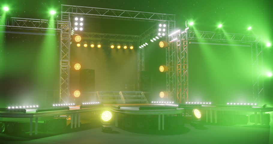 A brightly lit stage setup features numerous lights and sound equipment, designed for performances at concerts or events. The vibrant green and yellow hues create an energetic atmosphere.