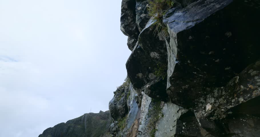 Madeira, Pico do Arieiro—cliffside hike video along a narrow path carved in volcanic rock, clouds sweeping over high mountain ridges