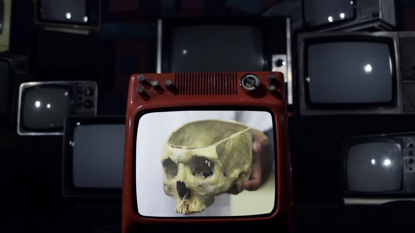 Scientist Displays Human Skull on Retro TV Set, Sudden Screen Explosion