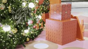 Smooth gliding close-up video of Christmas tree decorations with twinkling fairy lights, shiny baubles, rich green pine branches and warm holiday glow, backdrop ideal for winter celebration, New Year. - Powered by Shutterstock - Get 15% off with code: PIKWIZARD15