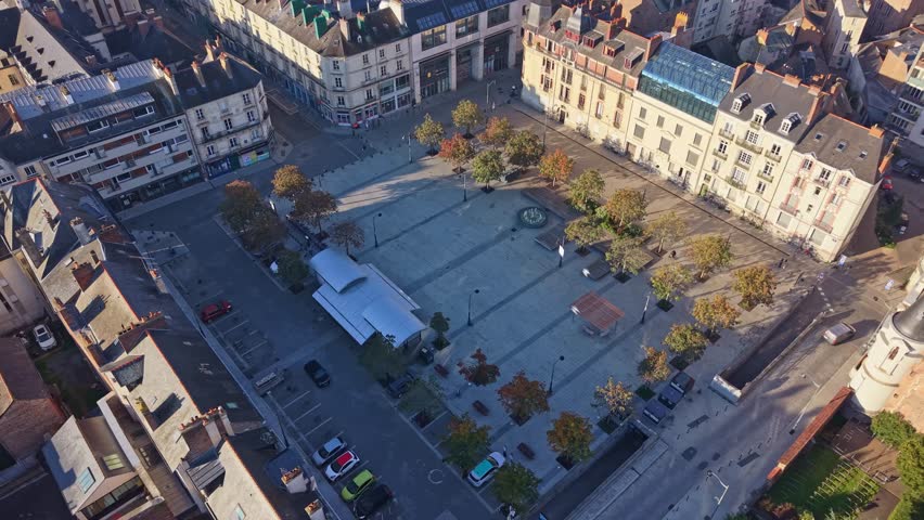 Aerial over buildings and a central square in Rennes with bright daylight across the city, Place Hoche