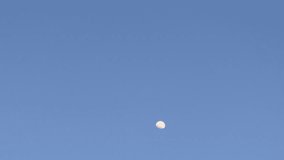 Time-lapse of the moon rising as the sky gradually darkens, showcasing a smooth transition from dusk to night. - Powered by Shutterstock - Get 15% off with code: PIKWIZARD15