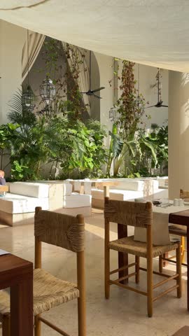 Escape to our serene, bionic-designed restaurant where lush greenery meets natural wood elements, creating a tranquil oasis perfect for a relaxing meal. Experience a modern indoor garden atmosphere.
