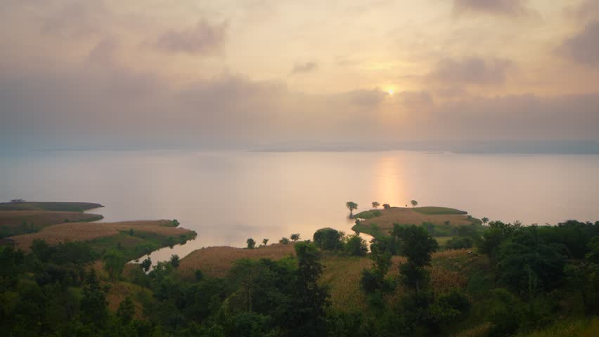 Apocalyptic sunset and clouds over forest lake, timelapse Chacha Kota, near Udaipur, Banswara, Rajasthan, India.