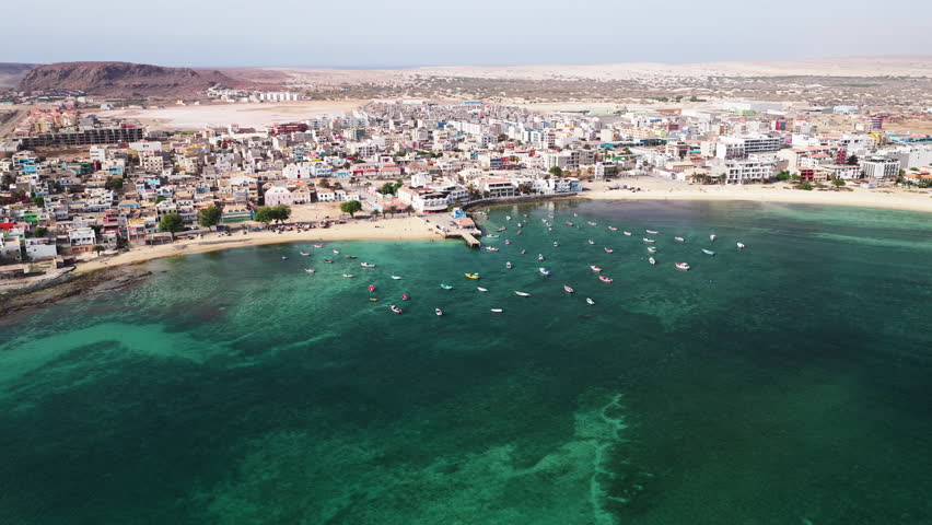 Aerial view of Sal Rei, Old city with many colorful house, small port, turquoise ocean and sandy beach, background the desert,Boa Vista, Cape Verde
