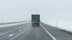 Chilly Antarctic voyage exploring vast icy wilderness. Embark on freezing adventure through expansive icy landscapes of North. Cargo truck advances across snow covered highway under dreary sky - Powered by Shutterstock - Get 15% off with code: PIKWIZARD15