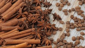 Slow Motion Rotation of Cinnamon Sticks, Star Anise and Coffee Beans on Wooden Surface with Warm Brown Aromatic Spices Background - Powered by Shutterstock - Get 15% off with code: PIKWIZARD15