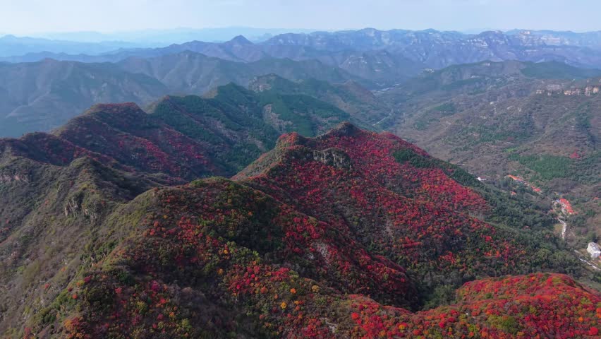 Aerial view of autumn scenery: layered forests and overlapping mountain ranges