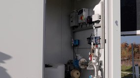 Industrial control panel with various components and piping, showcasing mechanical systems in action, camera pans to reveal intricate details and functionality - Powered by Shutterstock - Get 15% off with code: PIKWIZARD15