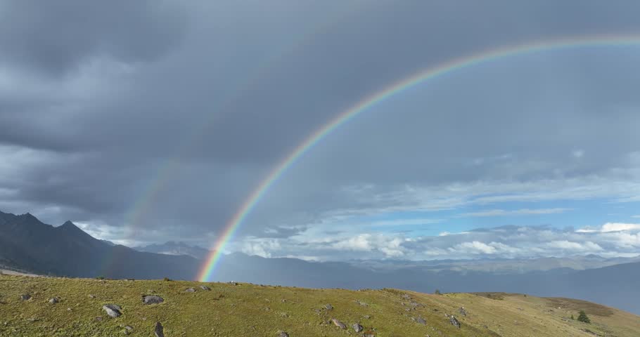 Beautiful  double rainbow after the rain on high altitude mountain top