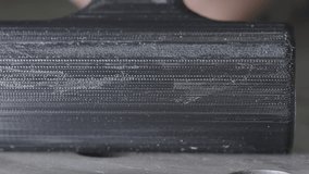 A close-up view of the texture of a black part printed on a 3D printer from PLA plastic - Powered by Shutterstock - Get 15% off with code: PIKWIZARD15