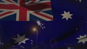 Woman, man waving sparkler on balcony, spark igniting Aussie flag graphic rippling, celebrating ads. Overlay, silhouettes, night, urban, reflections, glass, lamppost - Powered by Shutterstock - Get 15% off with code: PIKWIZARD15