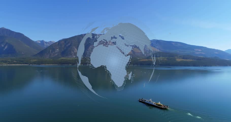 Globe appearing over lake, rotating as barge moving left leaving wake, representing global trade. Earth, aerial, water, mountains, towboat, drone, reflections