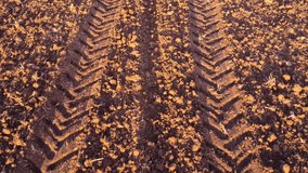 Sunset Perspective: Fast Tracking Shot Over Tractor Tracks. - Powered by Shutterstock - Get 15% off with code: PIKWIZARD15