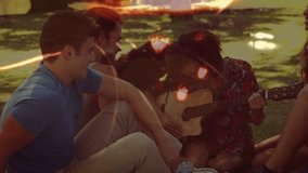 Central woman picking up guitar and strumming, friends leaning in to listen, light leaks overlaying. Instrument, acoustic, circle, park, outdoor, sunlit, nostalgic - Powered by Shutterstock - Get 15% off with code: PIKWIZARD15