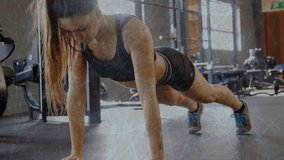 Woman starting high plank and lowering chest toward rubber mat then pushing up for gym strength. Pushups, athlete, fitness, workout, training, focus, sunlit - Powered by Shutterstock - Get 15% off with code: PIKWIZARD15