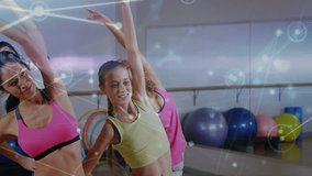 Fitness class doing stretches in sync, camera widening revealing overlay syncing motion for workout. Studio, choreography, group, rhythm, mirror, barre, graphic - Powered by Shutterstock - Get 15% off with code: PIKWIZARD15