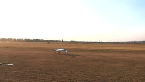 Small airplane takes off from grass airstrip of small airport. Lightweight plane move at rural runway and starting flight. Ultralight sport aircraft detach from airfield. Aviation concept. Aerial view - Powered by Shutterstock - Get 15% off with code: PIKWIZARD15