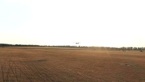 Small airplane with propeller engines flying in a clear blue sky. Aerial view to lightweight plane flight above rural airport. Travel at ultralight sport aircraft. Aviation concept. Drone shot - Powered by Shutterstock - Get 15% off with code: PIKWIZARD15