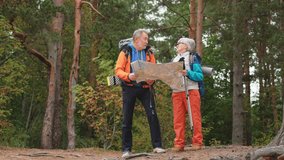 Hiking tourism. Senior couple man woman looking track in paper map enjoying hiking in forest. Happy old people backpackers hikers enjoy walking hike trekking tourism active vacation beauty of nature - Powered by Shutterstock - Get 15% off with code: PIKWIZARD15