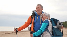 Hiking tourism adventure. Senior couple man woman enjoying outdoor recreation hiking on beach. Happy old people backpackers hikers enjoy walking hike trekking tourism active vacation beauty of nature - Powered by Shutterstock - Get 15% off with code: PIKWIZARD15