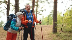 Hiking tourism adventure. Senior couple man woman enjoying outdoor recreation hiking in forest. Happy old people backpackers hikers enjoy walking hike trekking tourism active vacation beauty of nature - Powered by Shutterstock - Get 15% off with code: PIKWIZARD15