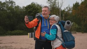 Hiking tourism adventure. Senior couple making selfie enjoying outdoor recreation hiking. Old people backpackers hikers taking photo enjoy walking hike trekking active vacation beauty of nature - Powered by Shutterstock - Get 15% off with code: PIKWIZARD15