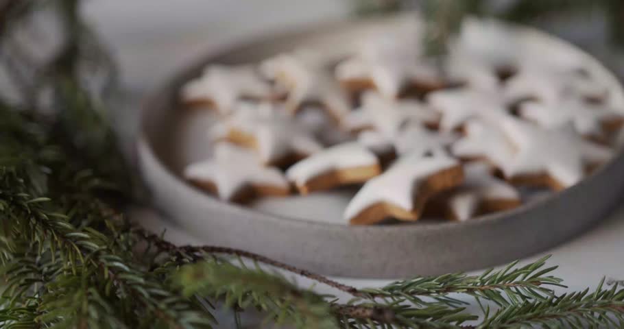 A close-up shot of star-shaped cookies arranged neatly on a plate. Perfect for holiday themes, Christmas baking, dessert presentations, food blogs, recipe videos, and festive culinary b-roll.